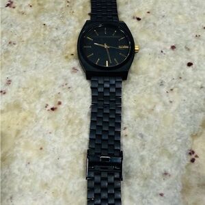 Nixon Black and Gold Timepiece